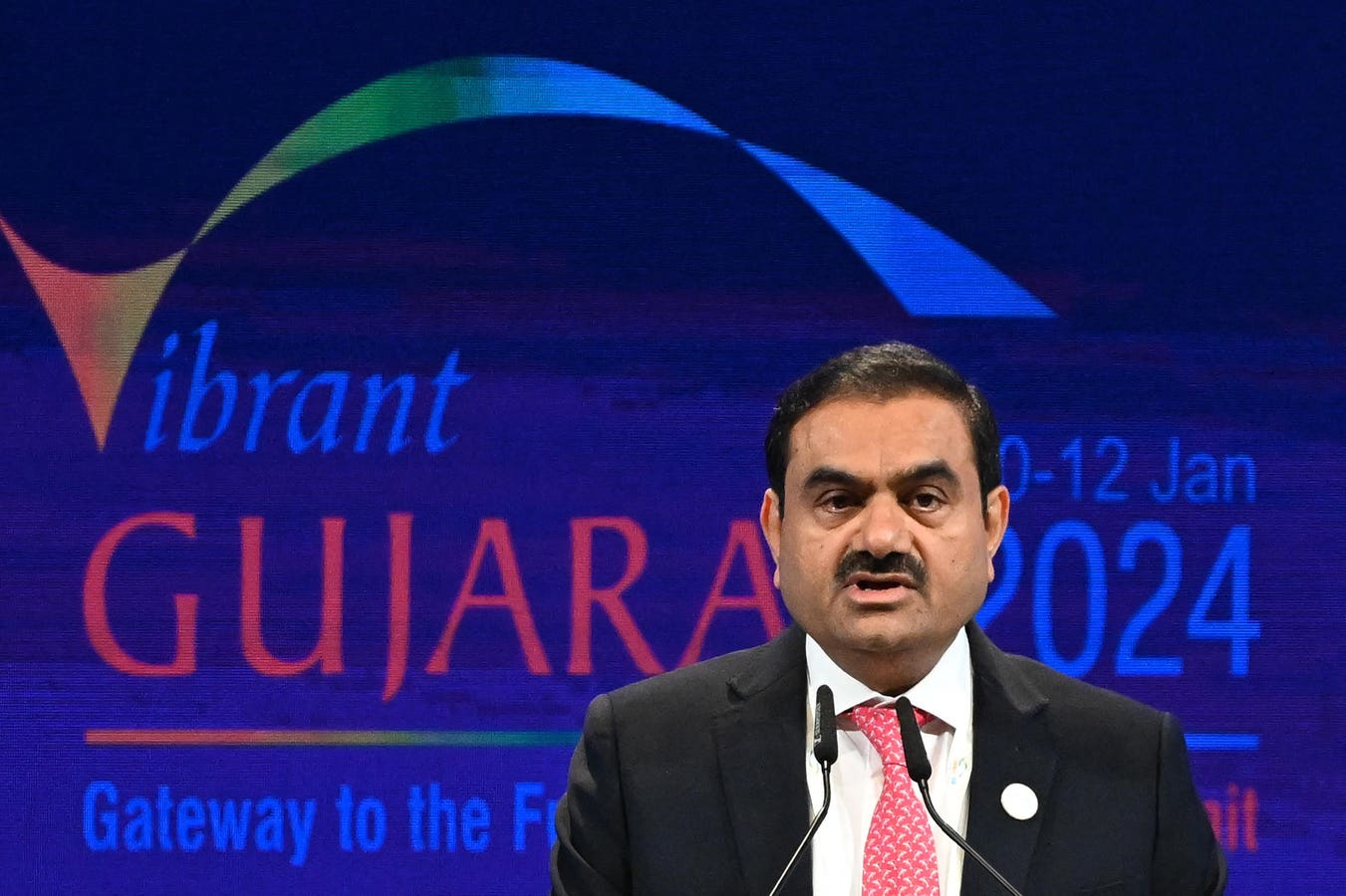 Gautam Adani speaking at a business event as Adani Enterprises announces a multibillion dollar capital raise and aluminium joint venture in India