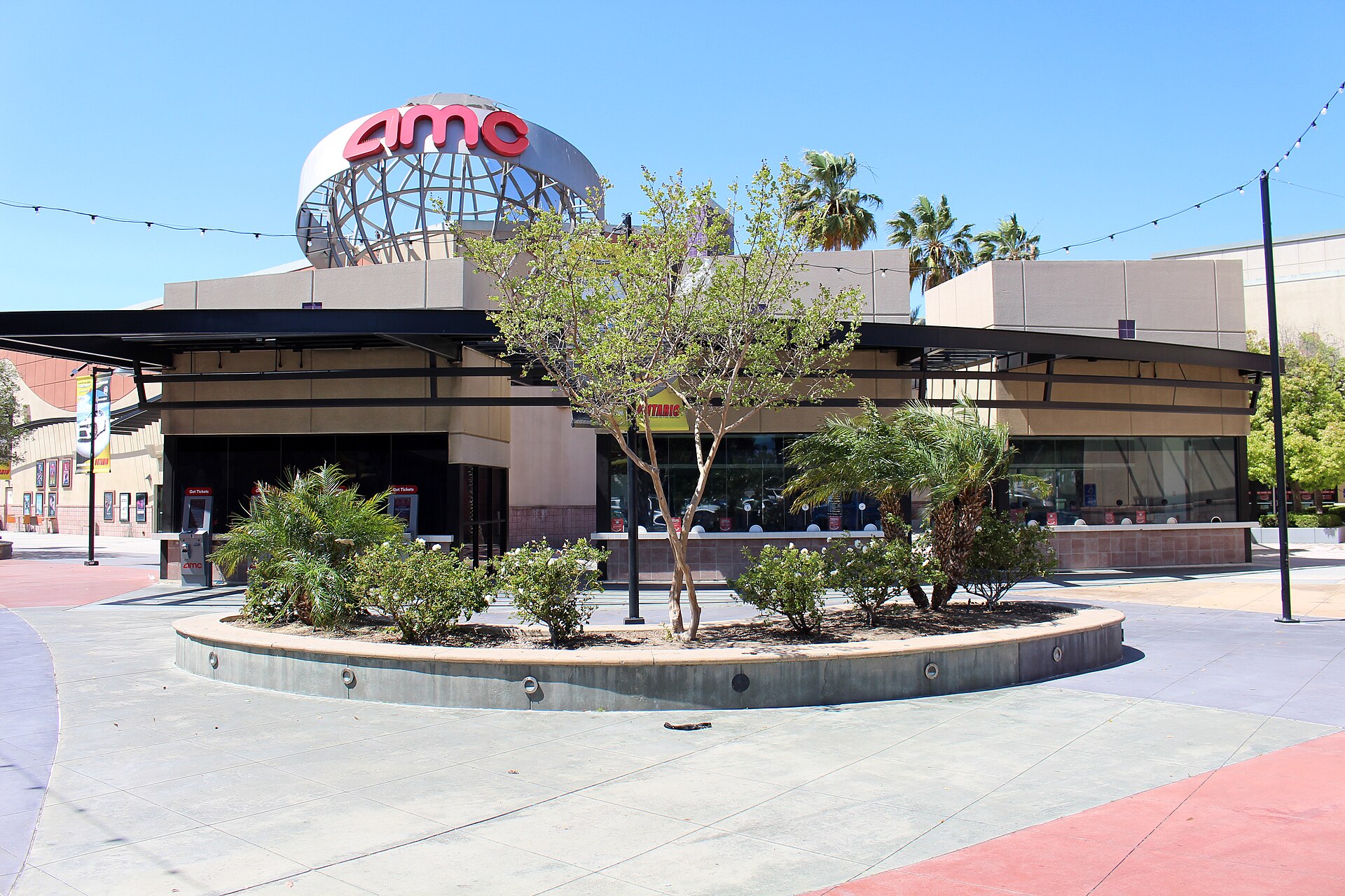 Exterior of the AMC Ontario Mills 30 multiplex in Ontario, California, part of a circuit that operated 845 theatres and 9,530 screens worldwide at the close of the June 2026 quarter. Photo: Coolcaesar / Wikimedia Commons, CC BY-SA 4.0