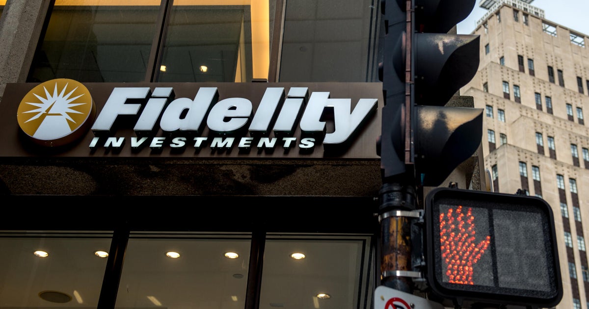 Fidelity Investments office building in Boston with employees walking toward the entrance during a weekday morning commute