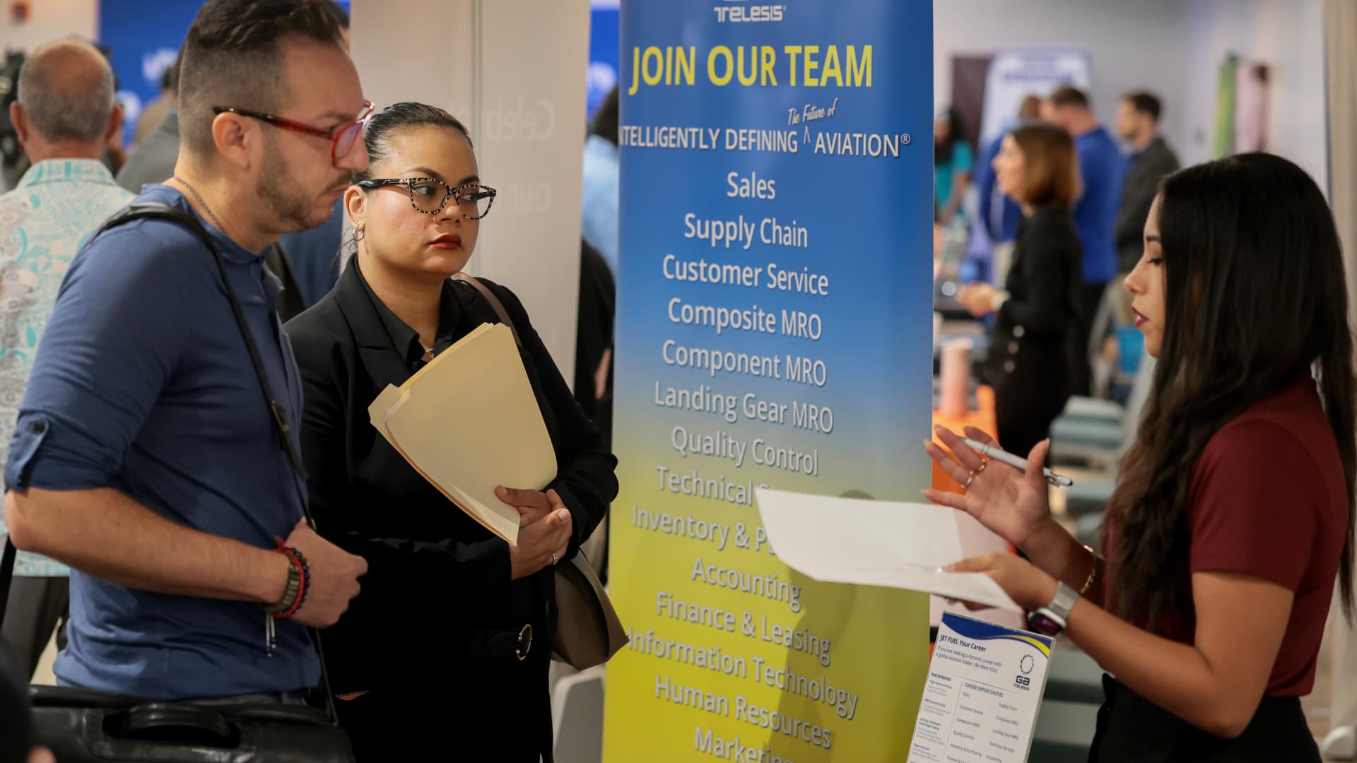 Job seekers review listings at a US hiring event as June payroll growth slows. Photo: CNBC