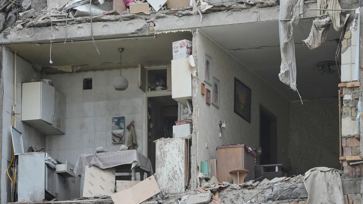 Emergency crews search a damaged residential block in Kyiv after a Russian missile and drone barrage. Photo: NPR