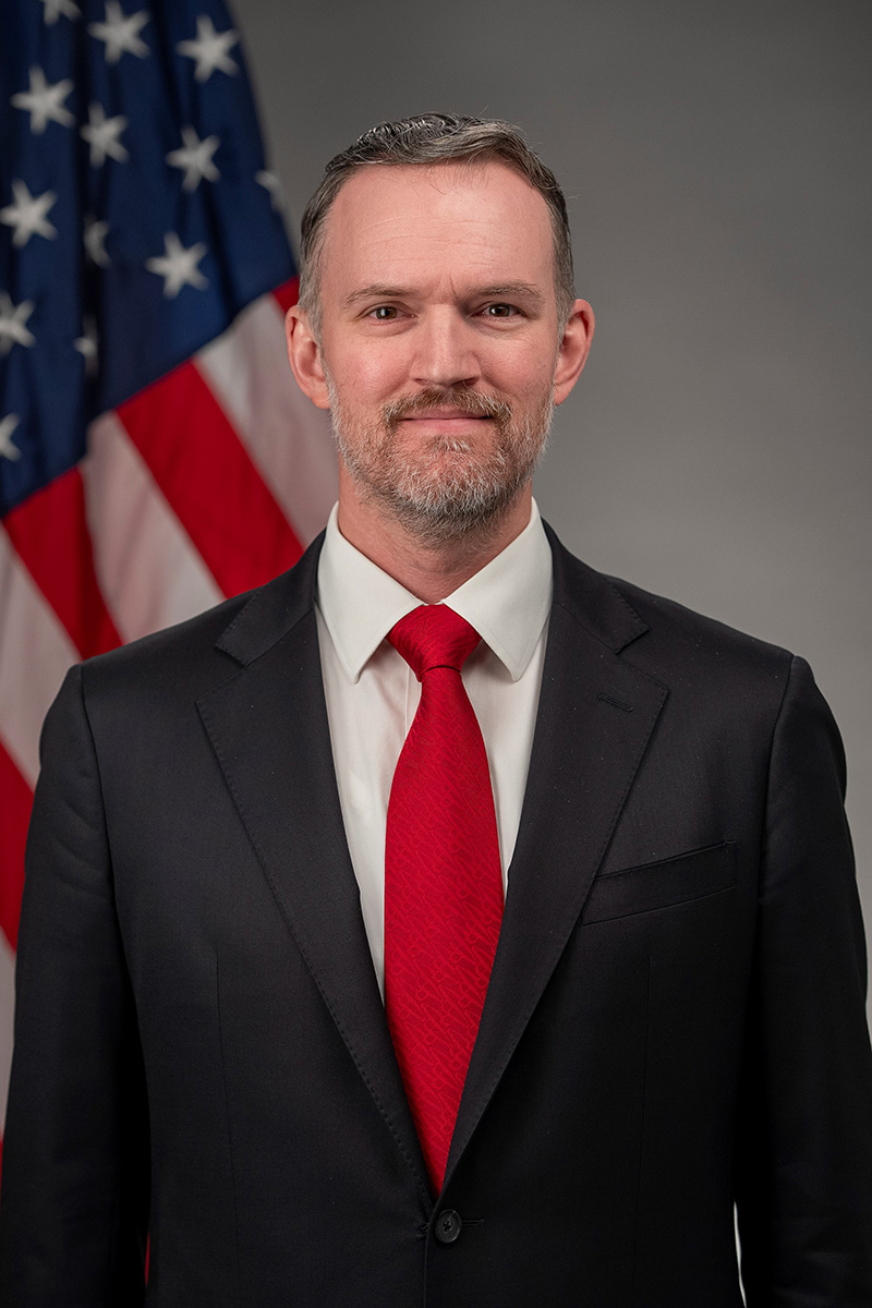 Official portrait of US Trade Representative Jamieson Greer, who announced the tiered duties, in a dark suit beside an American flag. Photo: Office of the United States Trade Representative / Wikimedia Commons, Public domain.