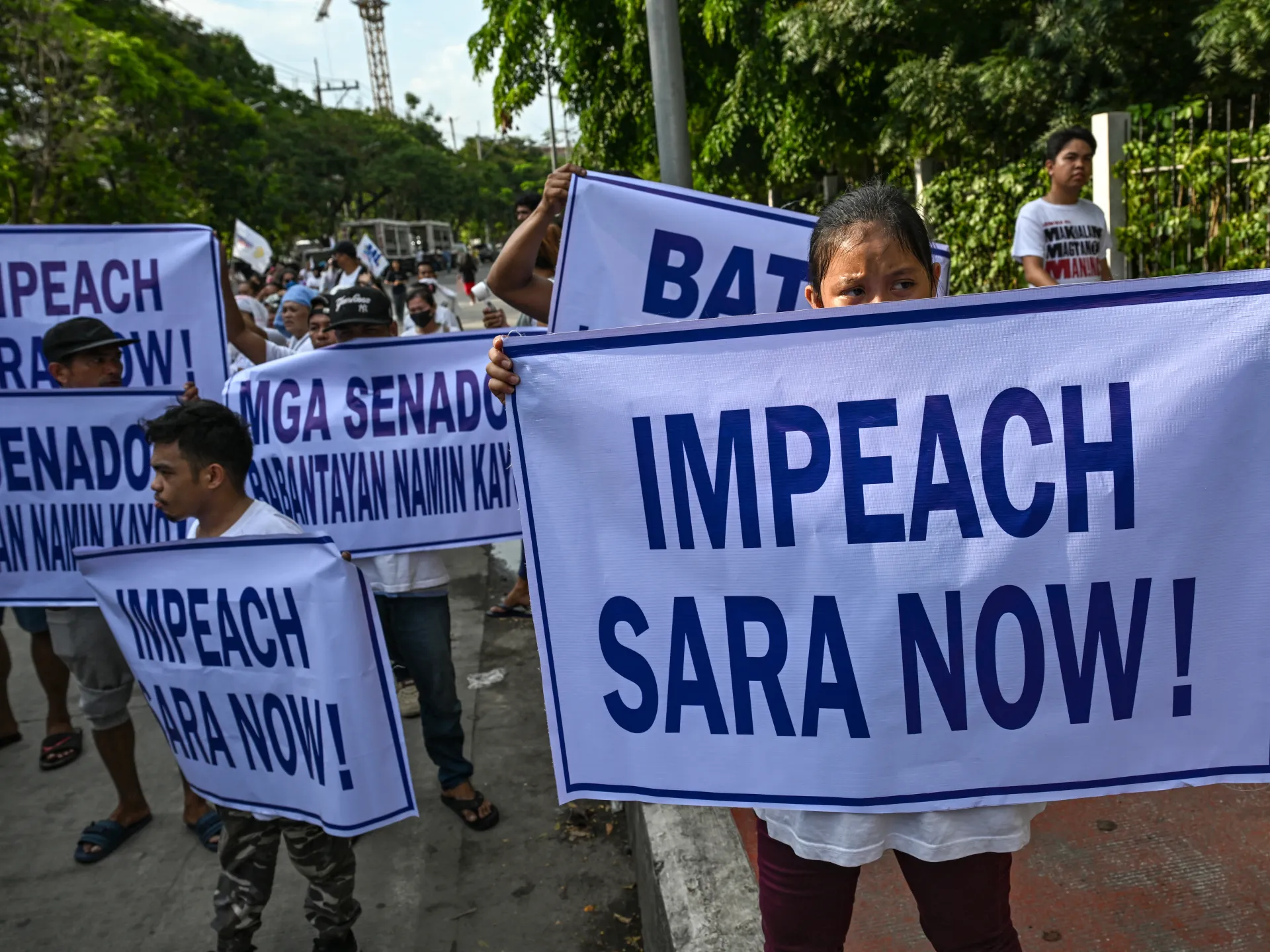 Protesters gather outside the Philippine Senate as Sara Duterte's impeachment trial opens in Manila. Photo: Al Jazeera