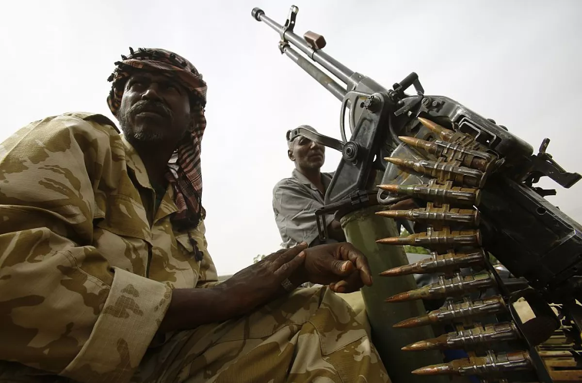 Armed fighters and smoke over the Central African border town of Am-Dafok after a deadly assault. Photo: Caliber.Az