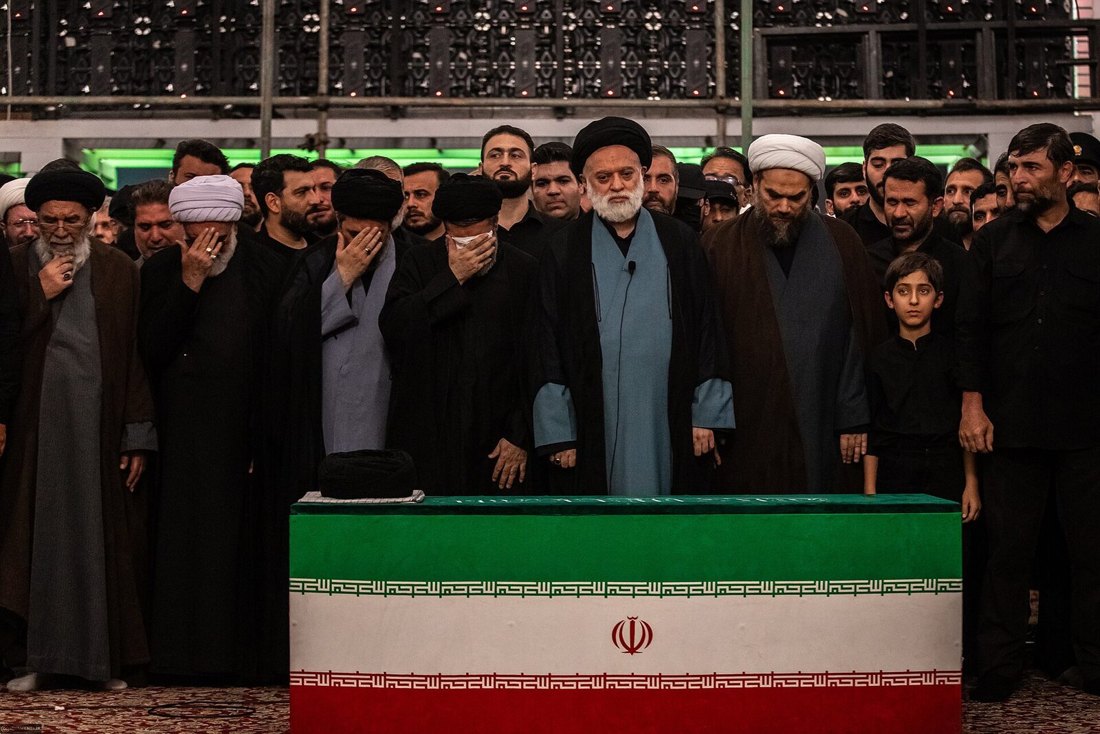 Mourners gather around the casket during funeral ceremonies in Iran. Photo: Khamenei.ir, CC BY 4.0, via Wikimedia Commons