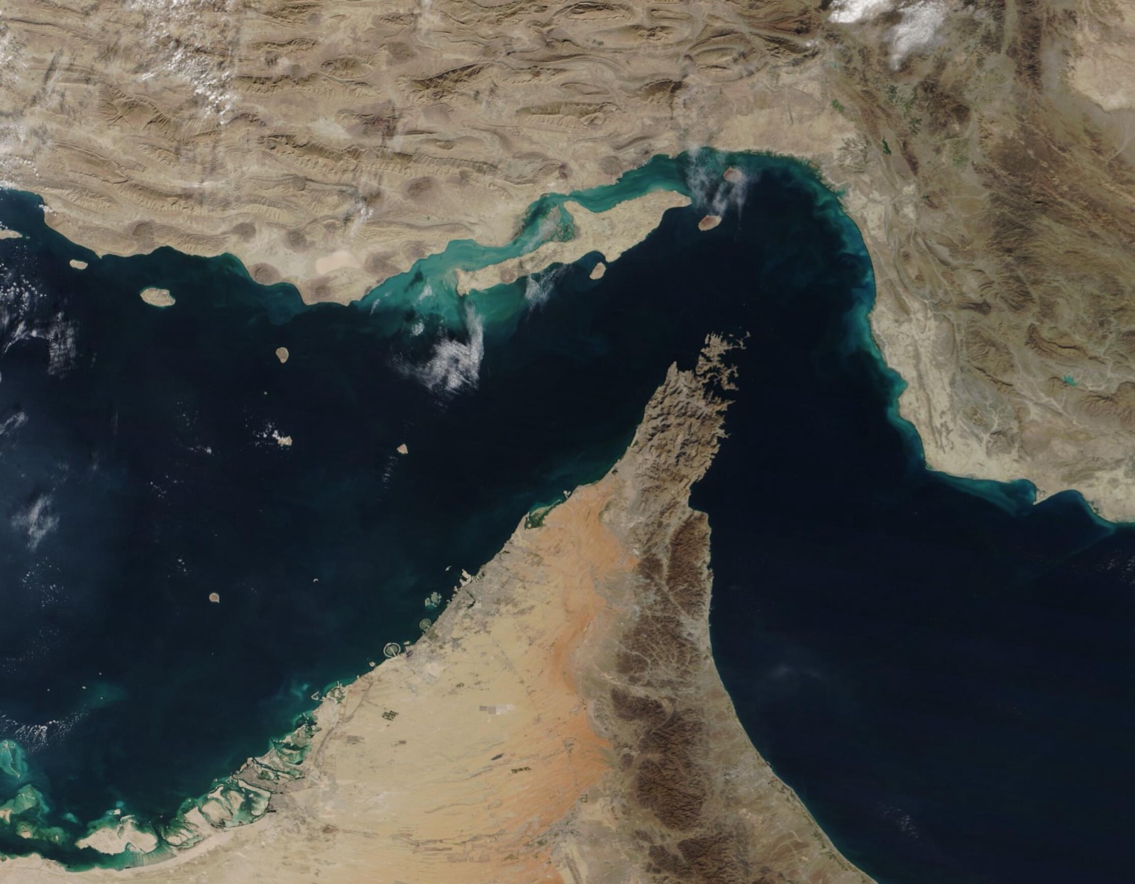 Satellite view of the Strait of Hormuz separating Iran from the Arabian Peninsula, the waterway at the center of the conflict. Photo: NASA MODIS Land Rapid Response Team / Wikimedia Commons, Public domain.